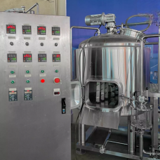 A stainless steel fermentation tank alongside a control panel with various dials and buttons.
