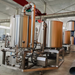 Stainless steel brewing equipment in a large industrial facility.