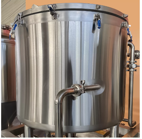Stainless steel brewing tank with a side outlet and blue hose connections.