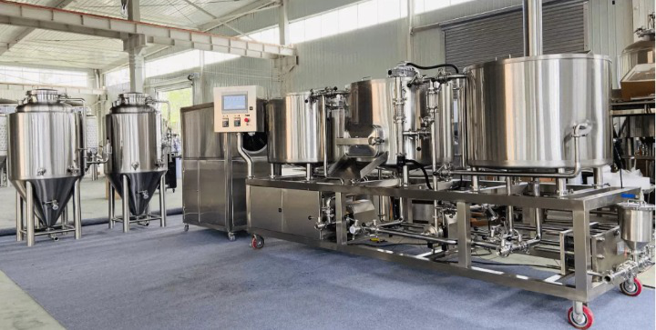 Industrial brewing equipment arranged for production in a factory setting.