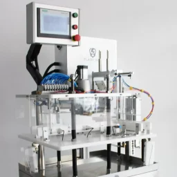 Close-up of a metallic, spoked wheel with a central knob, mounted on a device.