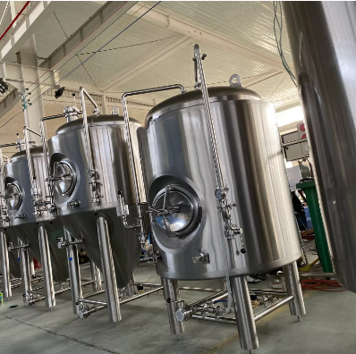 Stainless steel brewing tanks in a production facility.