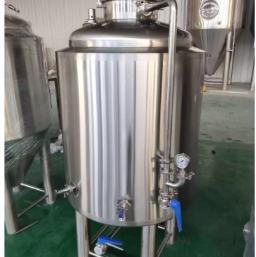 Stainless steel brite tank with valves and a pressure gauge.