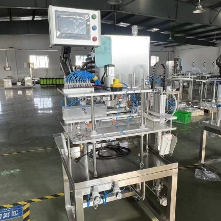 Industrial automatic canning machine with controls in a factory environment.