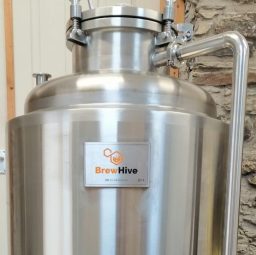A shiny 100L stainless steel fermenter.