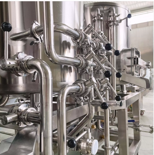 Industrial stainless steel piping and equipment in a manufacturing facility.