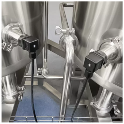 Close-up of stainless steel tanks with connected sensors and piping.