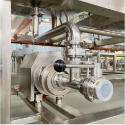 Stainless steel industrial piping and valves in a processing facility.