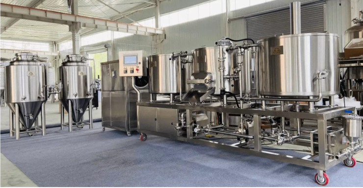 Industrial brewing equipment with stainless steel tanks and control panel in a factory setting.