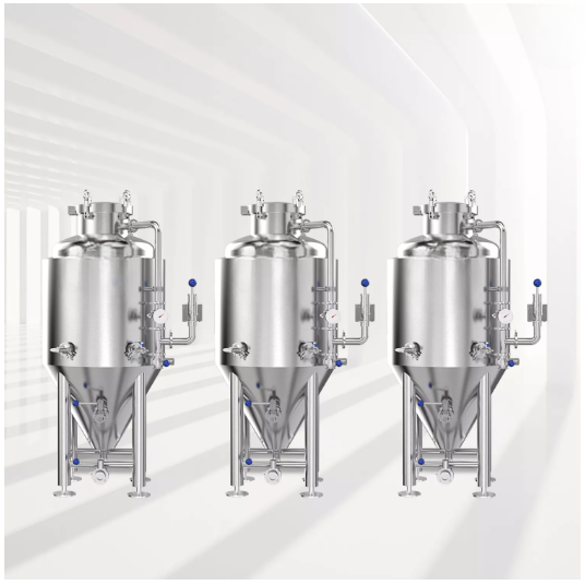 Three stainless steel processing tanks lined up in a modern industrial setting.