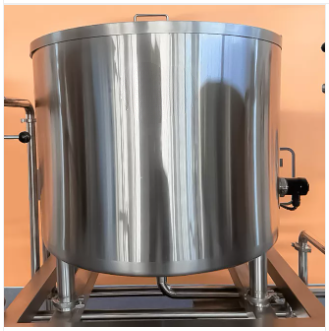 Stainless steel tank on a stand against an orange wall.