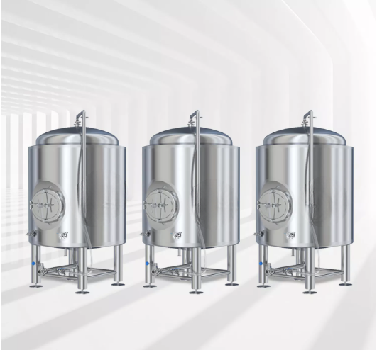 Three shiny stainless steel fermentation tanks in a bright, minimalist setting.