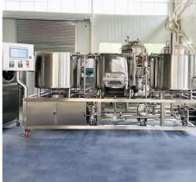 Industrial brewing equipment with stainless steel tanks and a control panel.